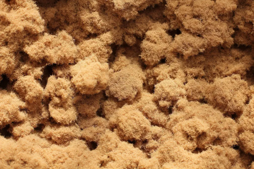 Close-up of loose, fluffy, light-brown wood fibre